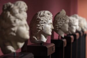 Row of classical busts on display in a museum in Flores, highlighting the island's rich cultural heritage. Ideal for a Flores travel guide exploring local museums and art.